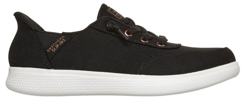 A black slip-on sneaker with white soles and rose gold eyelets.