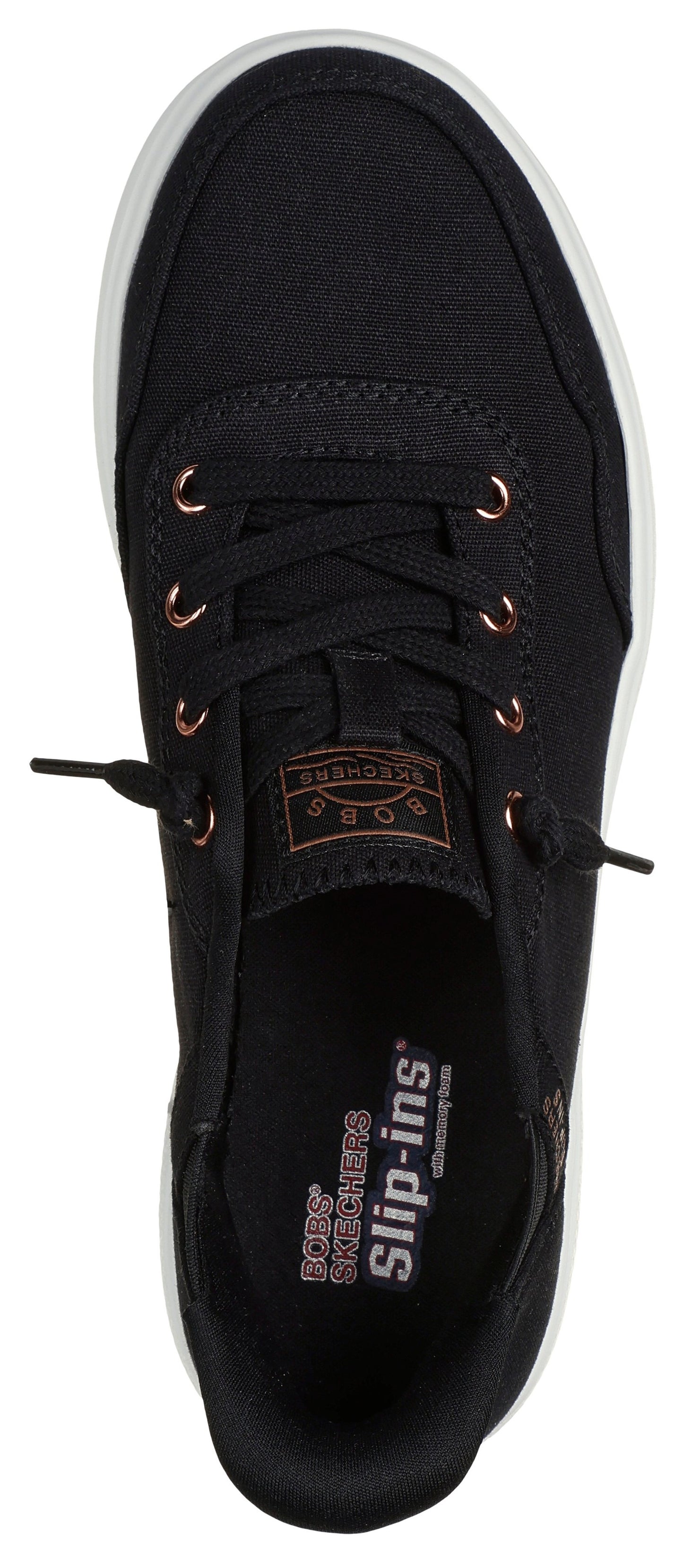 A black shoe with white sole and copper eyelets. The insole features "BOBS SKETCHERS Slip-ins" text.