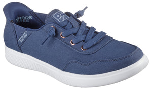 Slip-on blue canvas sneaker with white sole, eyelets, and laces. Text includes "Hands Free" and "Skechers".