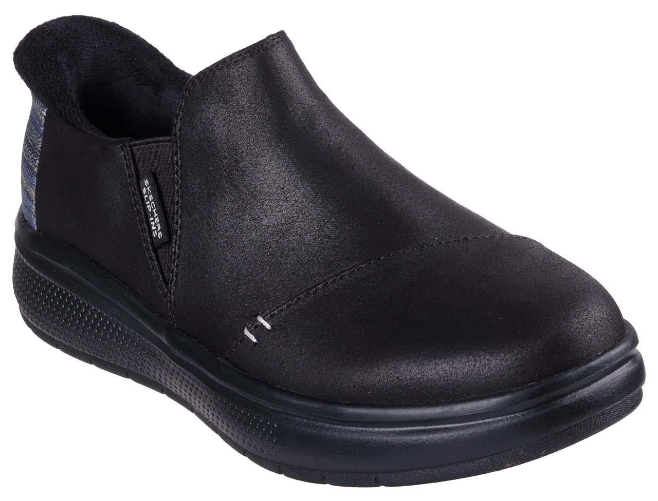 Black slip-on shoe with a low heel and a plaid panel near the heel.