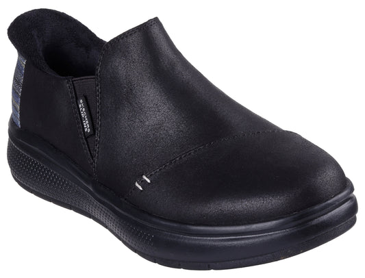 Black slip-on shoe with a low heel and a plaid panel near the heel.