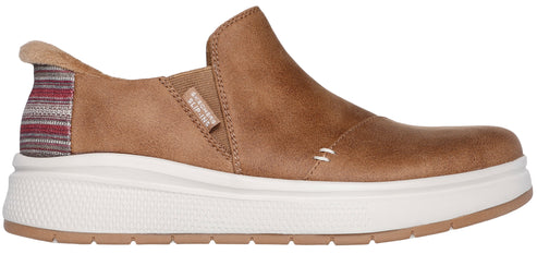 A tan slip-on shoe with a thick white sole and a colorful striped heel.