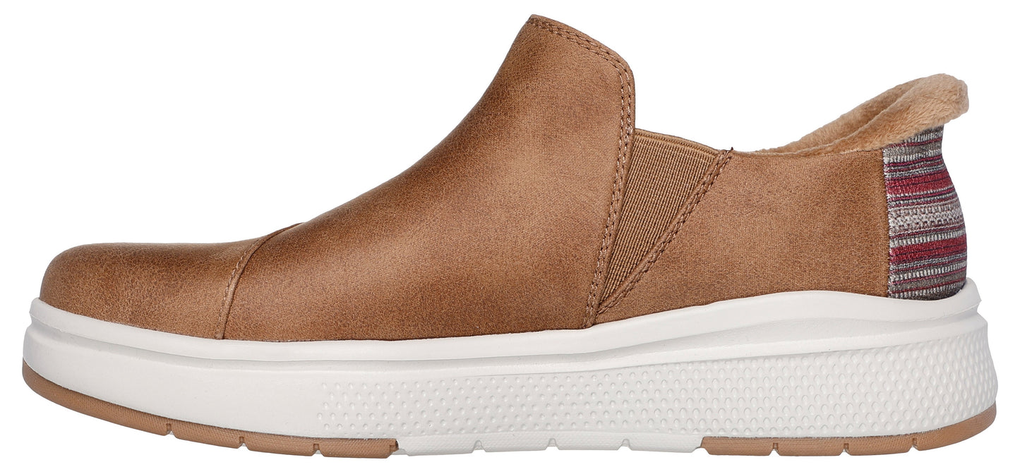 Tan slip-on shoe with a white platform sole and striped heel.