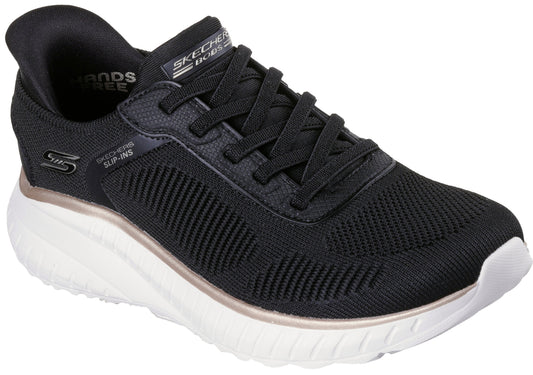 A black Skechers BOBS Slip-ins athletic shoe with a thick white cushioned sole, featuring black laces, a textured knit upper, and metallic rose gold trim between the upper and sole.