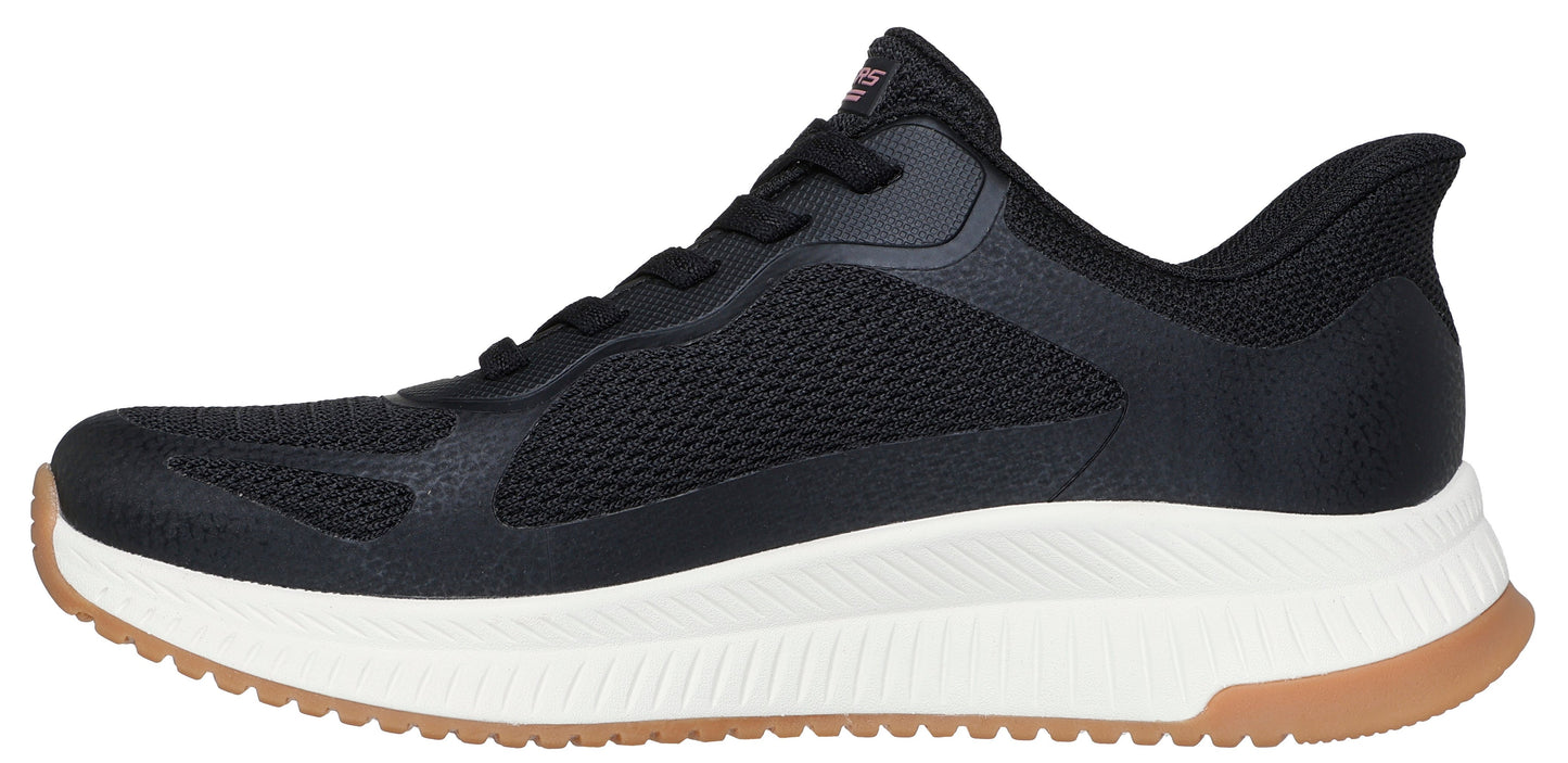 A black sneaker with a white and brown sole.