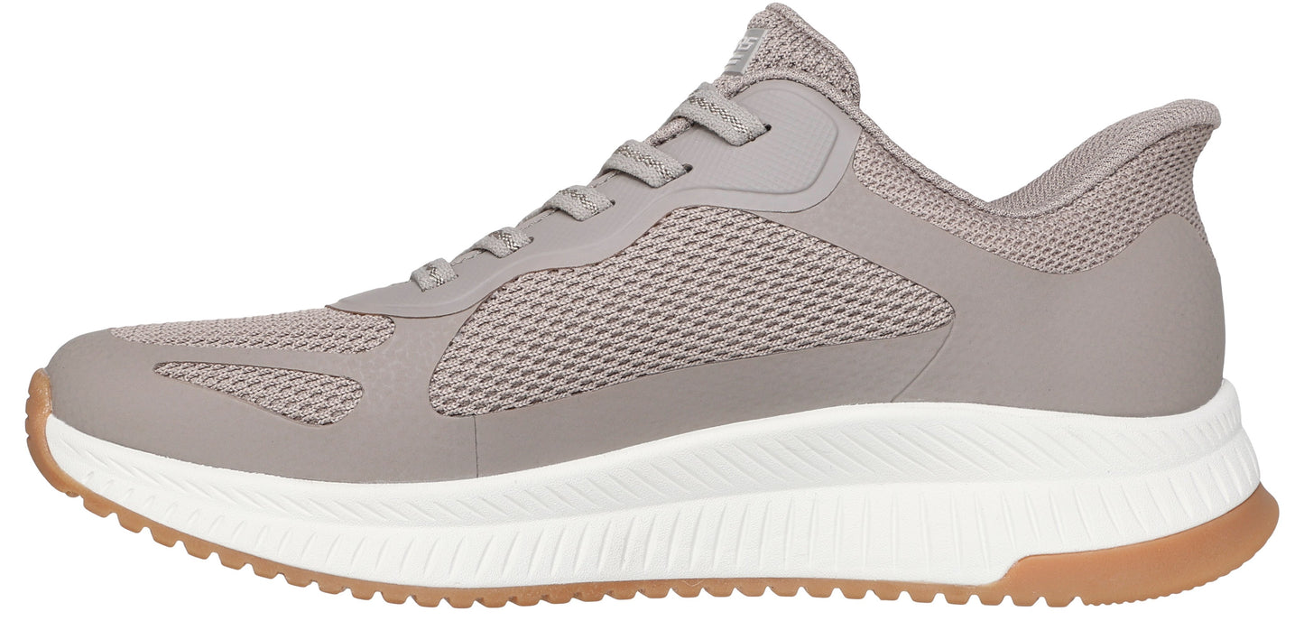 A side view of a gray athletic shoe with a white sole and brown accents.