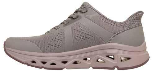 A light gray women's athletic sneaker with a breathable knit upper, laces, and a thick, chunky midsole featuring distinctive triangular cutouts along the side profile.