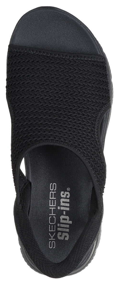 A black sandal with an open toe, an elastic heel strap, and the words "SKECHERS Slip-ins" on the insole.