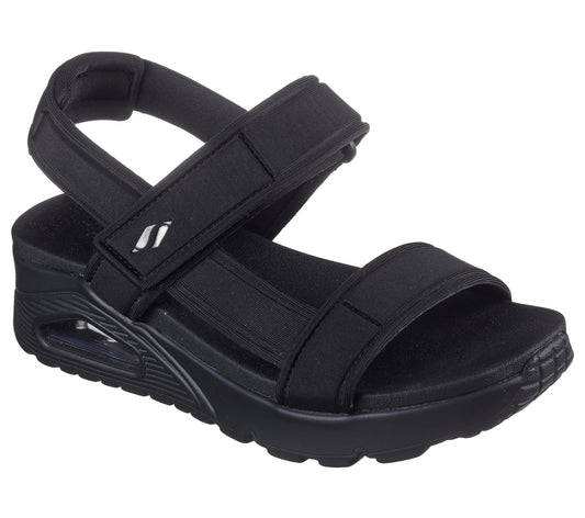 Black sandal with adjustable hook-and-loop straps and platform sole.