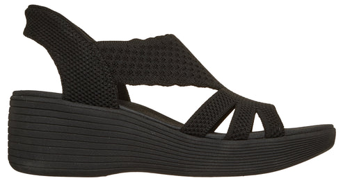 Black knitted sandal with a wedge heel and slingback strap.