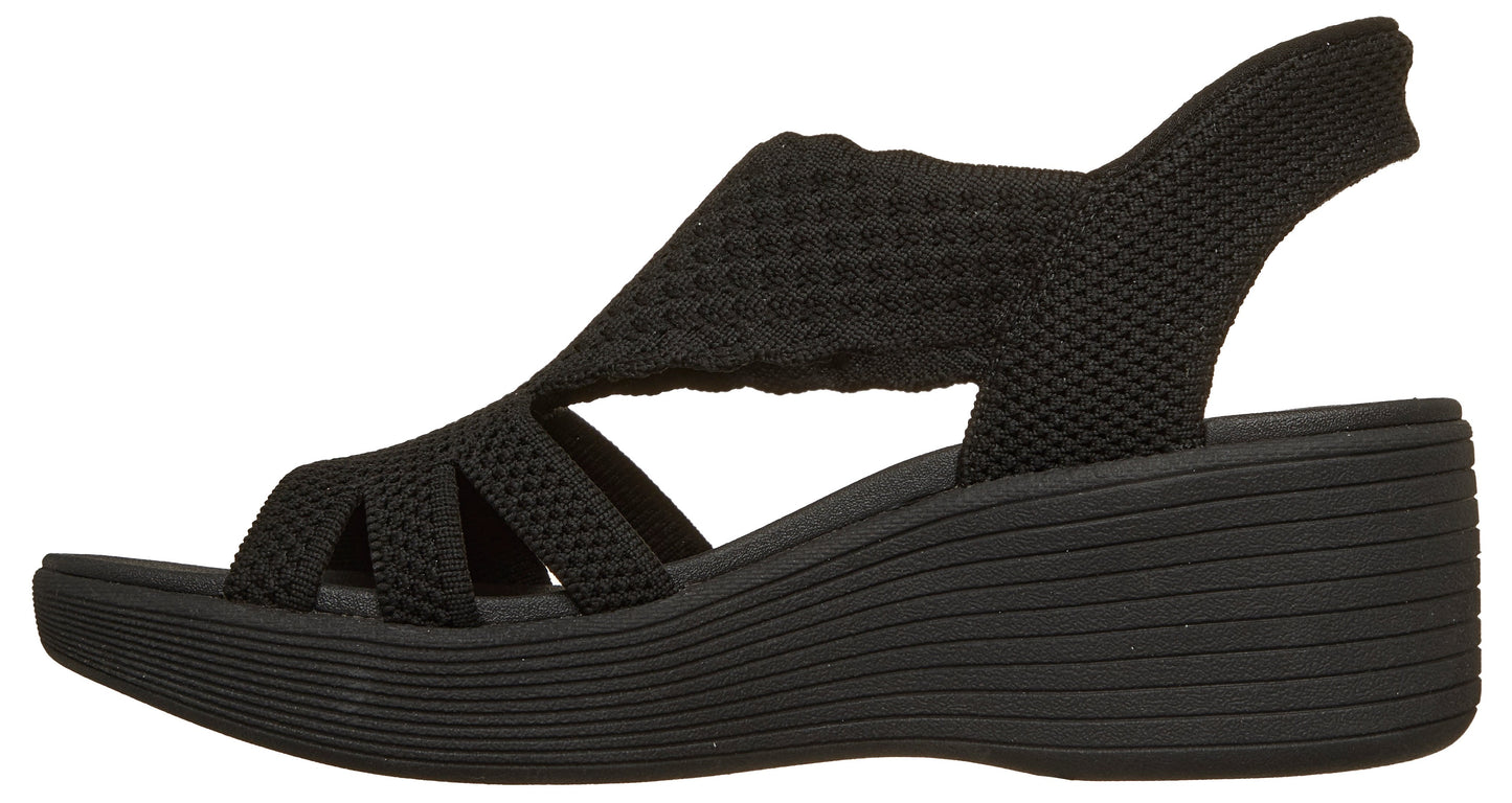 Black woven wedge heel sandal with open toe and slingback strap.
