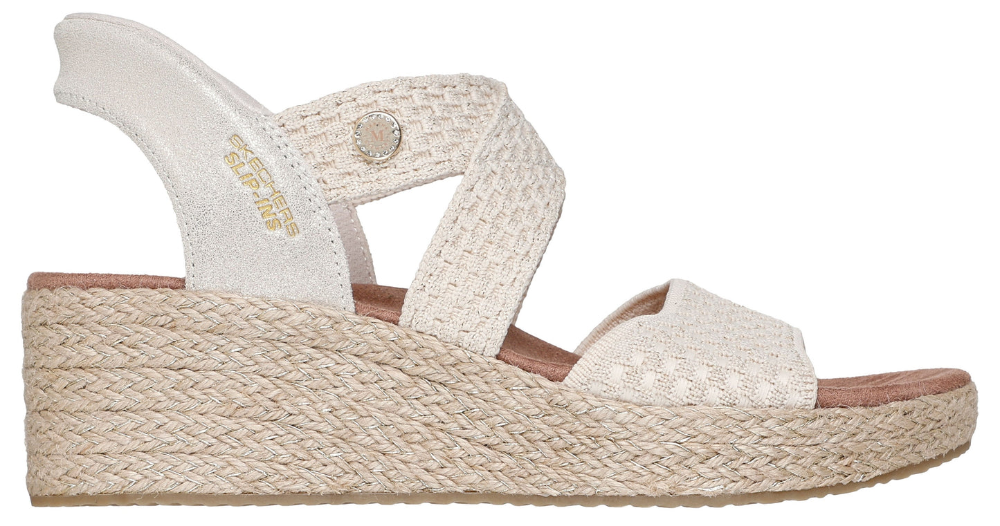 Womens off-white wedge sandal with woven crisscross straps and elastic ankle strap.