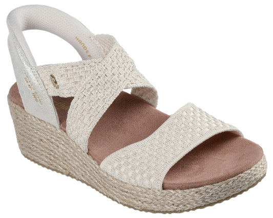 Espadrille wedge sandal with woven cross-straps, light gold heel, and elastic heel strap.
