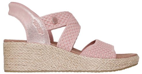 Pink espadrille wedge sandal with woven straps.