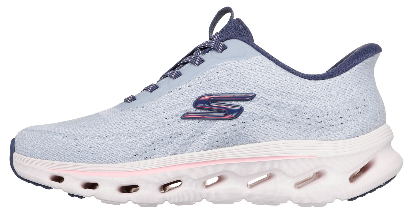 A light blue athletic shoe featuring a unique, cutout sole, a navy interior and a reflective logo on the side.