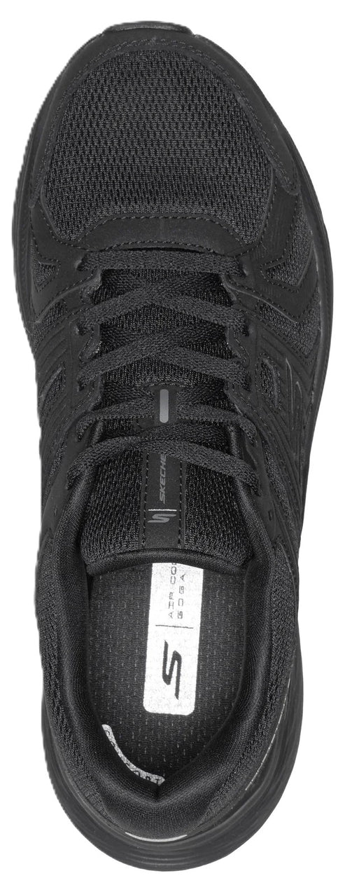 A top-down view of a black athletic shoe with laces, mesh material, and an insole featuring the letter S logo.