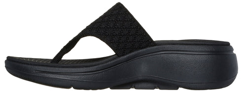 Black thong sandal with a knit strap and a wedge heel.