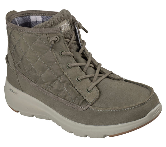 A tan, ankle-high lace-up boot with a quilted side panel, suede toe, fur-lined collar, and a thick, chunky beige sole.