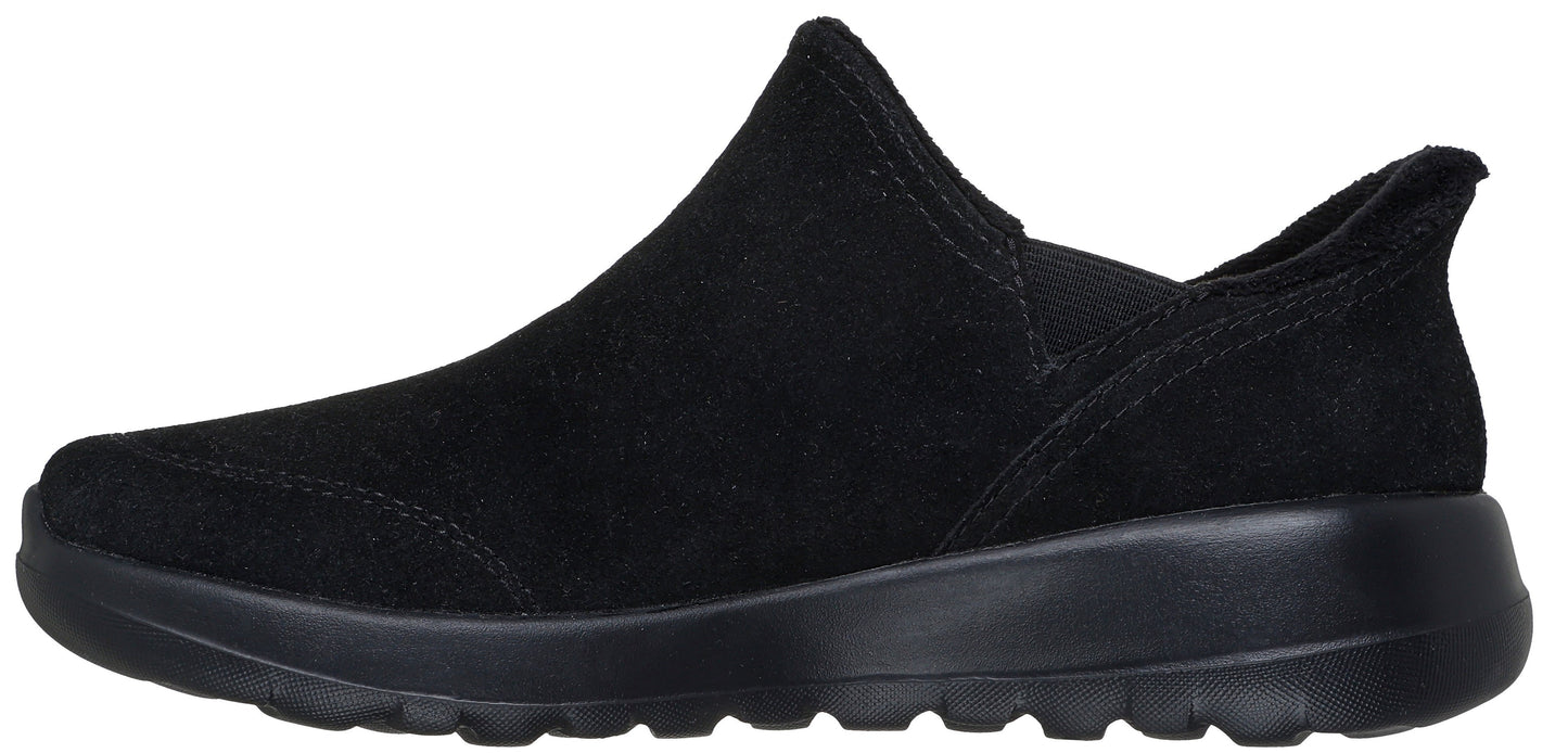 A black slip-on shoe with a raised instep.