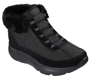 A black quilted ankle boot with a fuzzy faux-fur collar, a thick cushioned sole, and dark gray cord-style laces, featuring the visible text "SKECHERS COZY FIT" on the tongue.