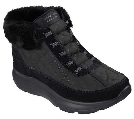 A black quilted ankle boot with a fuzzy faux-fur collar, a thick cushioned sole, and dark gray cord-style laces, featuring the visible text "SKECHERS COZY FIT" on the tongue.