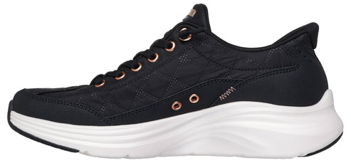 A black sneaker with rose gold accents and a thick white sole.