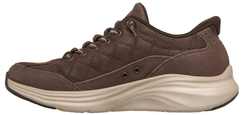 A brown quilted casual sneaker with a chunky, light tan wave-patterned midsole and slip-on style elastic laces.