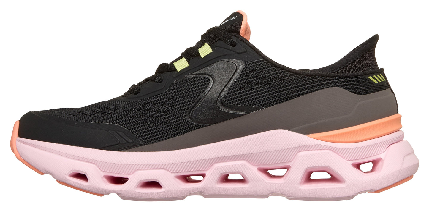 A black running shoe with peach and light green accents and a pink sole.