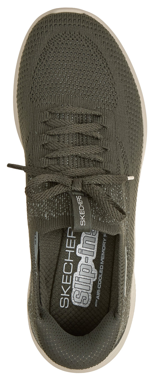 A top-down view of an olive-green slip-on sneaker featuring knitted fabric construction, tonal laces, and an internal cushioned insole with the text 'SKECHERS slip-ins' and 'AIR-COOLED MEMORY FOAM' printed on it.