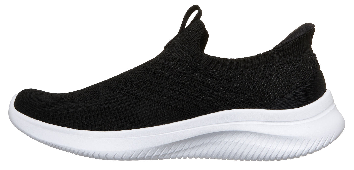 A black slip-on sneaker with a white sole.
