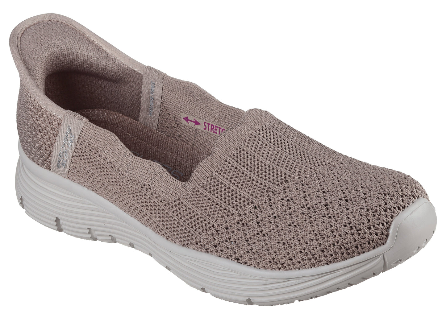 Slip-on light pink athletic shoe with stretchy knit upper and white soles.