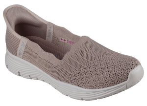 Slip-on light pink athletic shoe with stretchy knit upper and white soles.