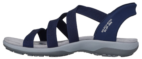 A navy blue sandal featuring multiple straps across the front and the side. The text "SKECHERS SLIP-INS" is visible on the side.