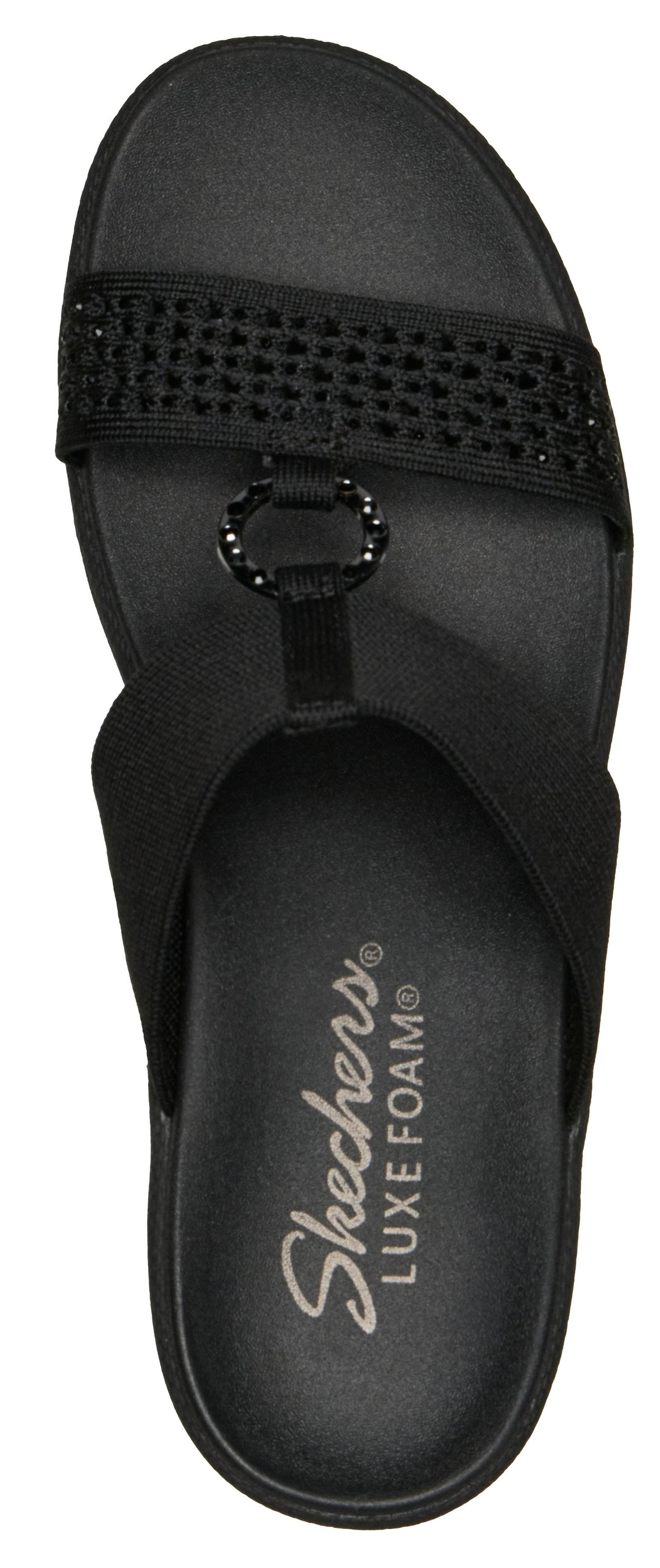 A black sandal with a jeweled strap and the text "Skechers LUXE FOAM" printed on the sole.