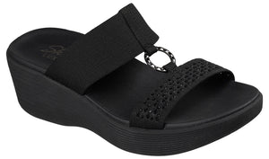 Black wedge sandal with two elastic straps and decorative ring.