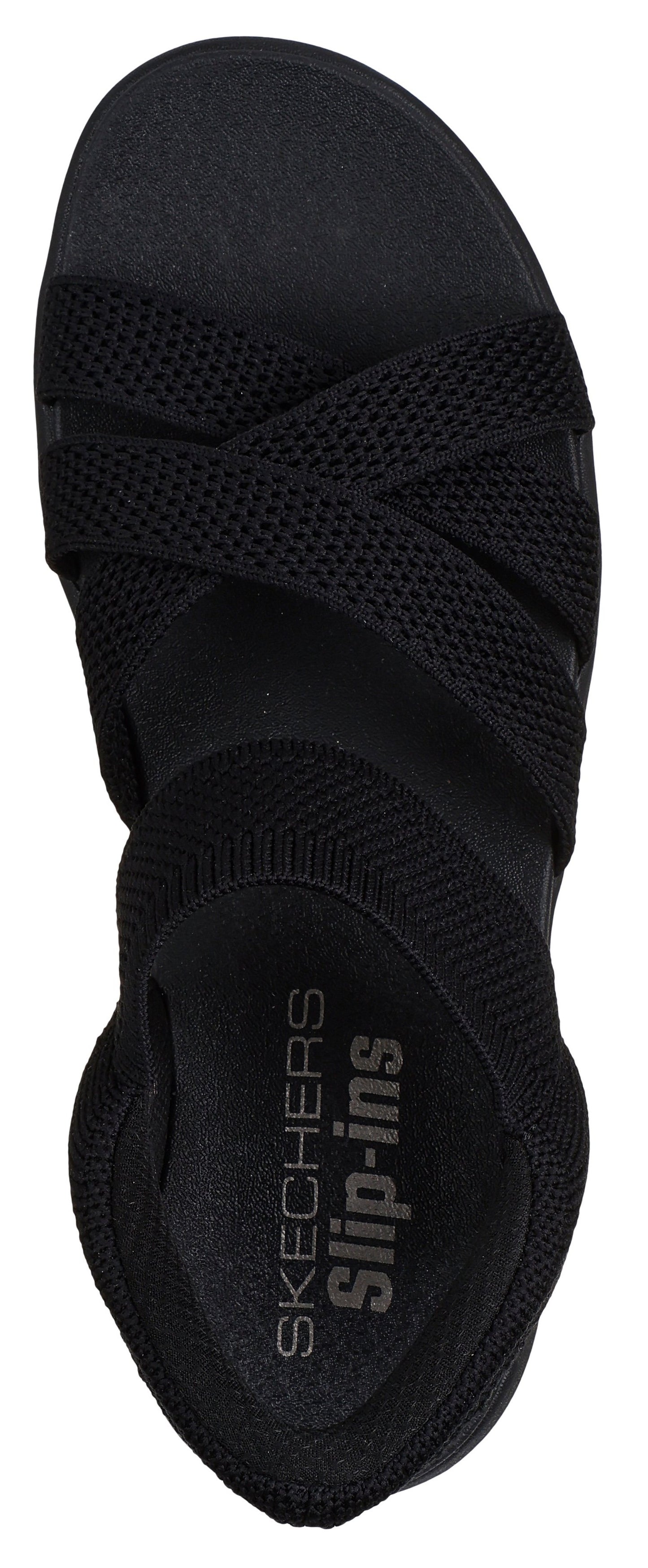 A black sandal with crisscross straps and the text "SKECHERS Slip-ins".