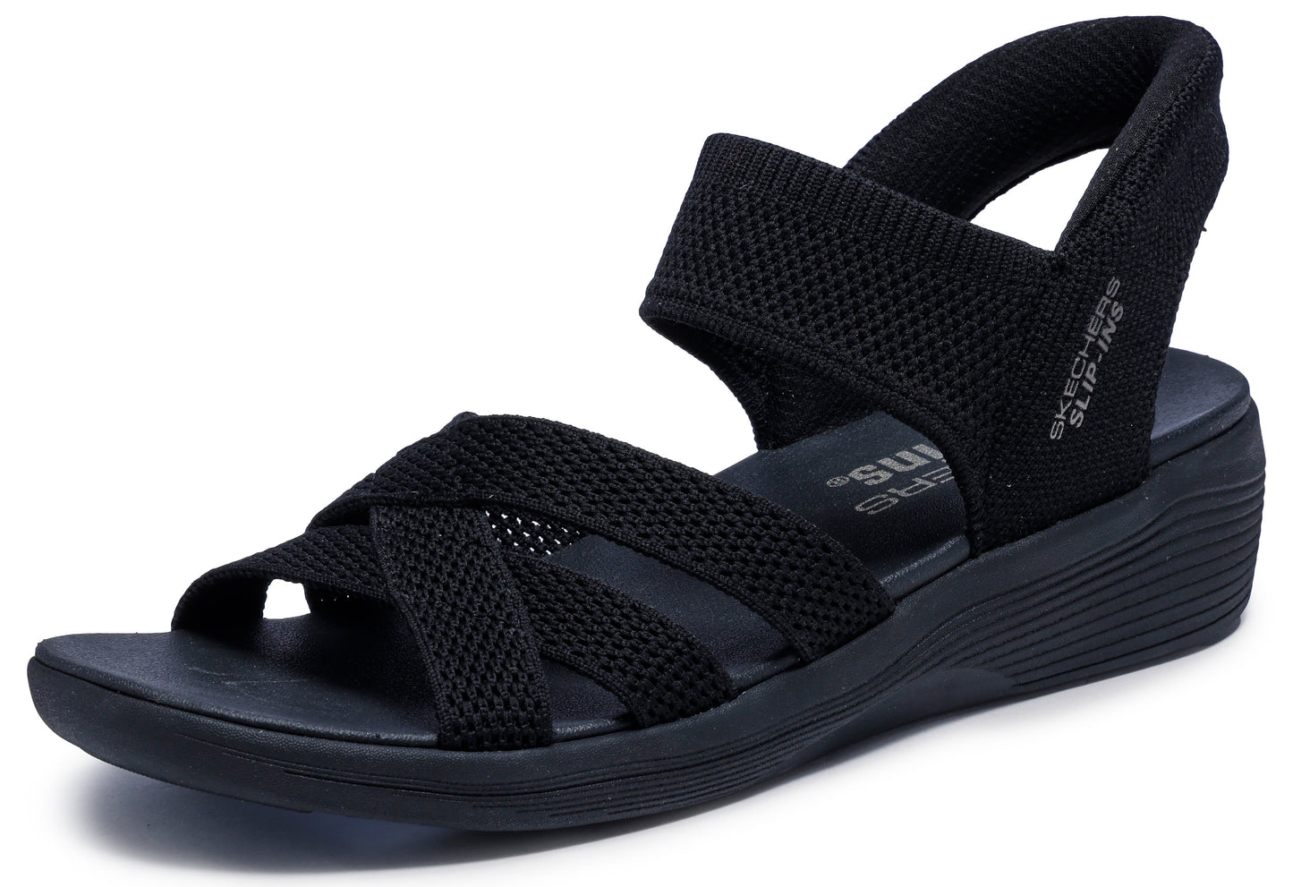 Black sandal with crisscross straps and wedge heel, featuring elastic straps and the text "SLIP-INS" on the heel strap.