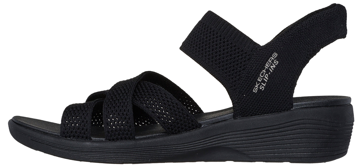 A black sandal with a criss-cross upper and back strap with "SKECHERS SLIP-INS" text.