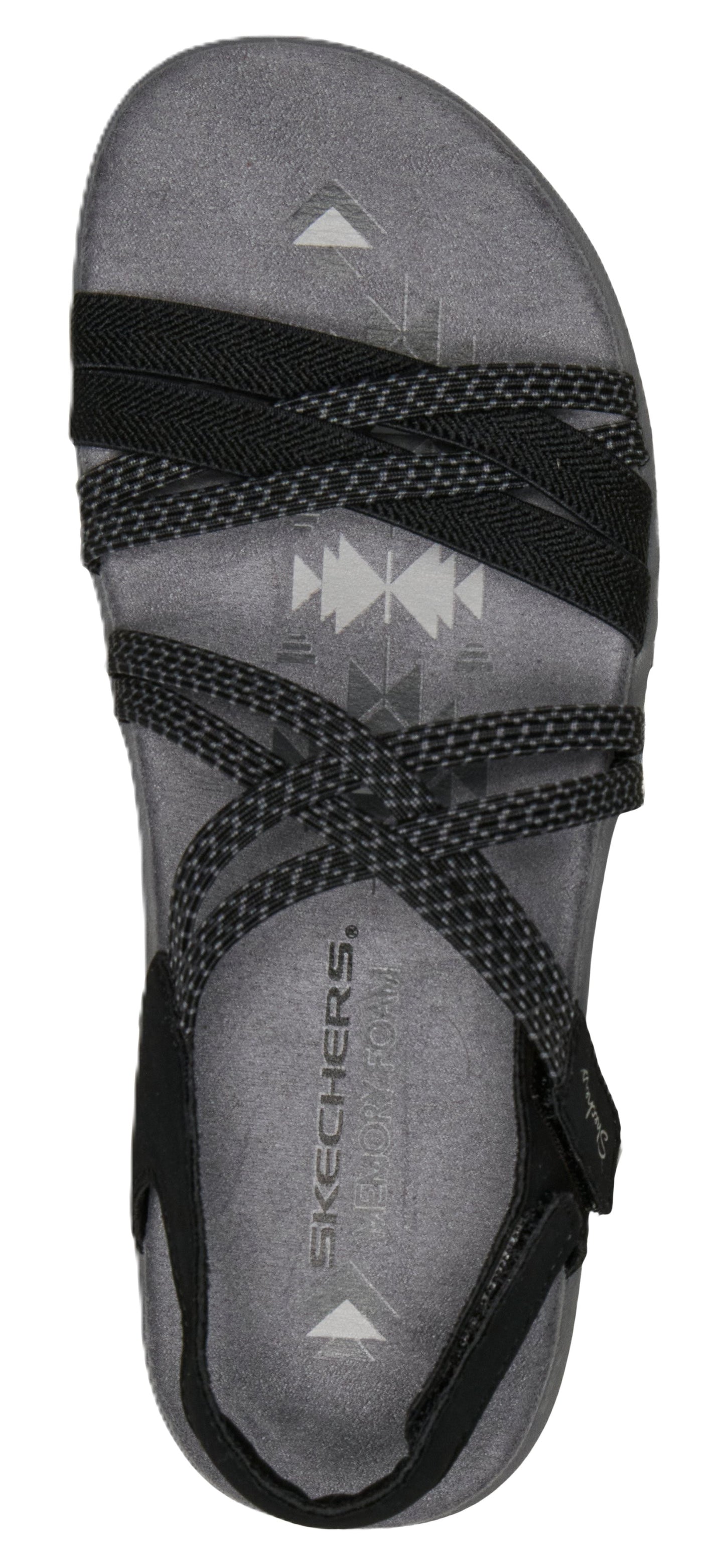 A top-down view of a sandal with multiple black crisscrossing straps on a gray textured insole.