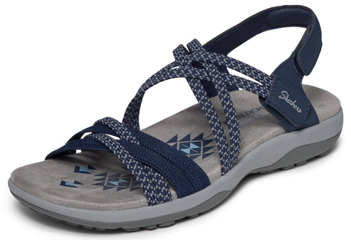 Navy blue sandal with multiple patterned straps, gray sole and "Skechers" text near heel.
