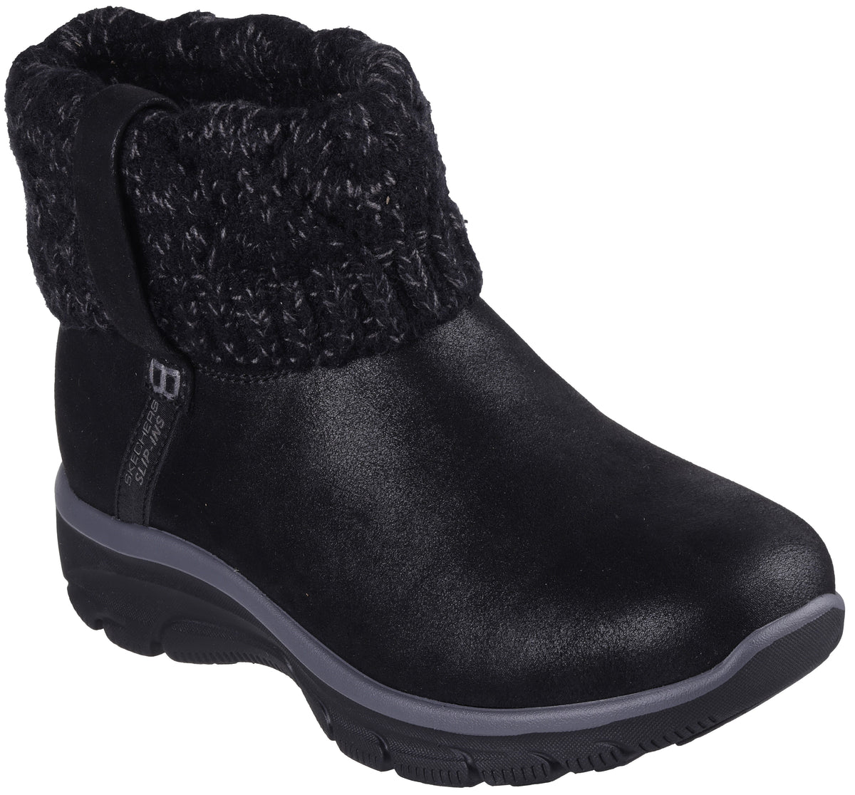 A black ankle boot with a smooth, matte-textured lower section and a thick, chunky knit sweater-style cuff at the top. The boot has a thick, dark gray midsole and a black treaded outsole, with a small vertical tag reading "SKECHERS" on the side.