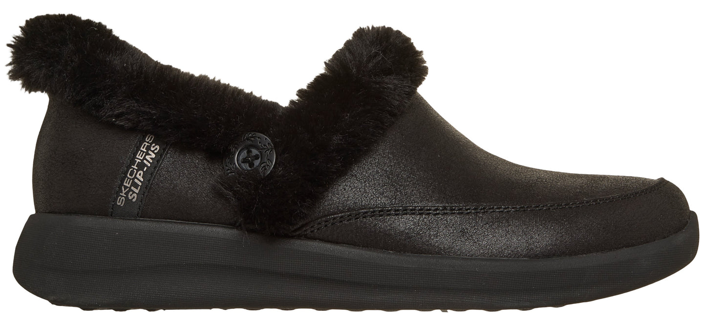 A black clog shoe with a faux fur trim and a button.