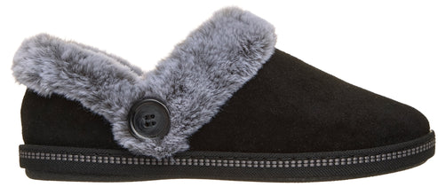 A black suede slipper with grey faux fur trim along the collar, accented by a black button on the side and a textured, decorative band around the base.