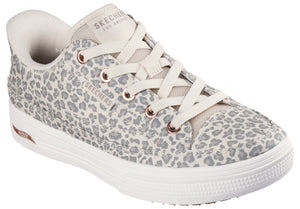 Leopard print sneaker with white laces, rubber soles, and visible "SKECHERS LOS ANGELES" text.