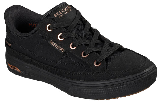 Black canvas low-top sneaker with black laces, copper eyelets and "SKECHERS LOS ANGELES" in copper on tongue and side.