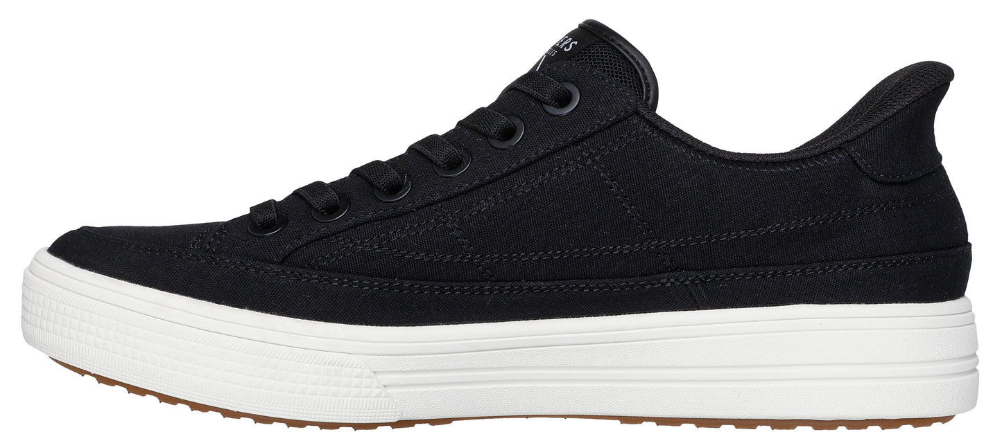 A black canvas sneaker with a white sole and brown tread.