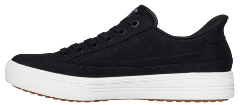 A black canvas sneaker with a white sole and brown tread.