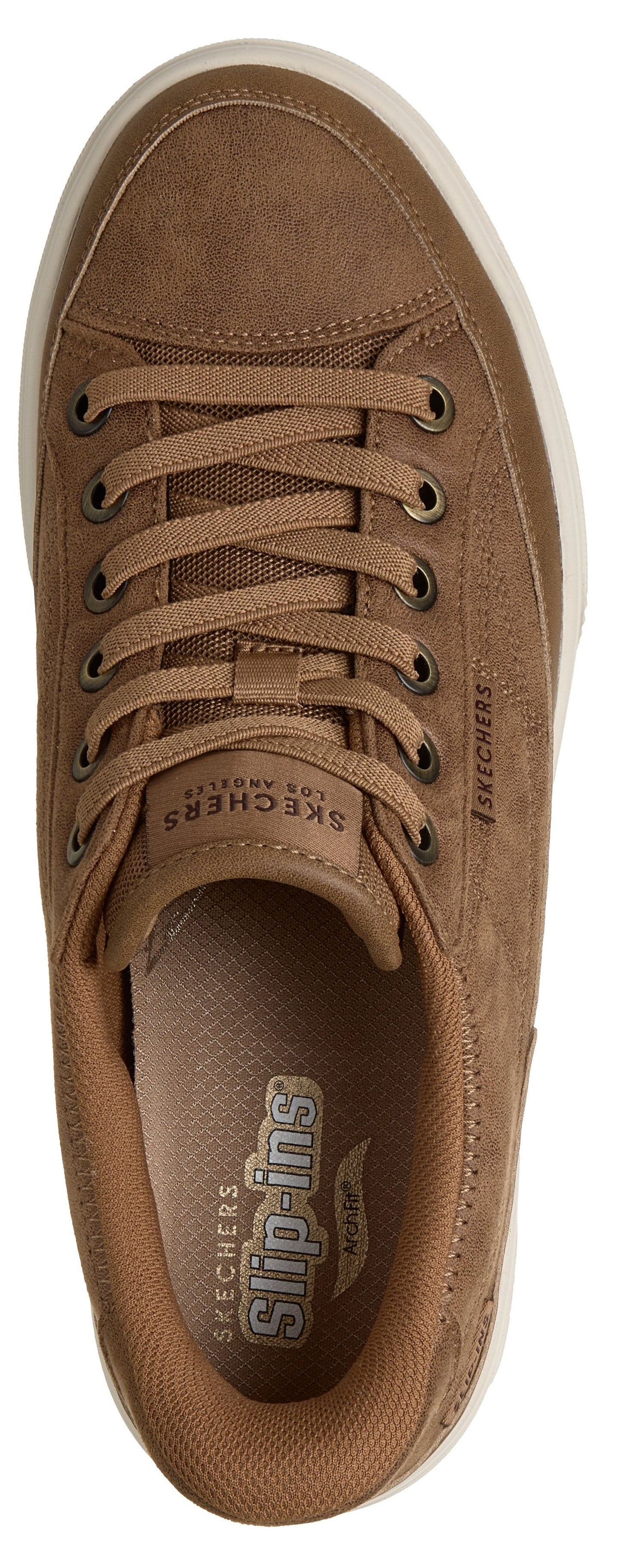 A top-down view of a light brown suede-like sneaker with matching brown laces and a white rubber sole, featuring interior branding that says "Skechers Slip-ins" and "Arch Fit".