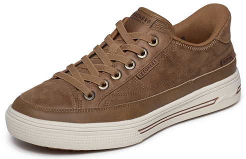 A brown suede low-top sneaker featuring a thick white rubber sole, matching brown laces, and the embossed word SKECHERS on the side and tongue.