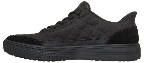 A black sneaker with a quilted fabric upper, a thick ribbed midsole, suede-like overlays at the toe and heel, and matching black laces.
